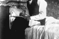 Intimate portrait of a man writing a letter, 1900-1910, John Oxley Library